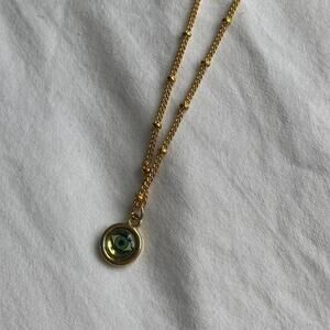 Gold eye necklace with green
